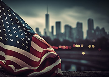 the American Flag with a blurry scene of New York City in the background