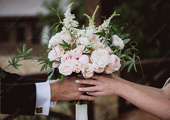 a newly married couple holding a bouquet of flowers