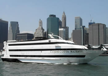 Cornucopia Majesty sailing in the Hudson River with the buildings of NYC in the background