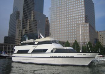 Cloud 9 III Yacht docked in marina with two big buildings