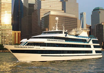Infinity Yacht in the Hudson river with sunshine reflected on well-designed buildings 