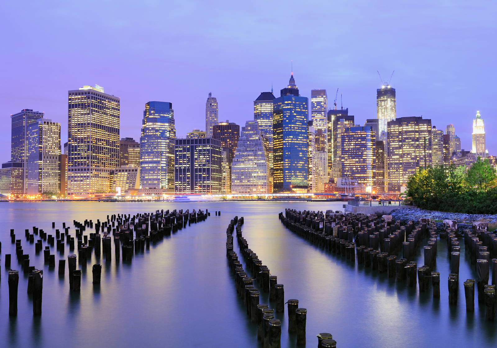 A beautiful view of NYC buildings during blue hour, seen from Caliber yacht on the river.